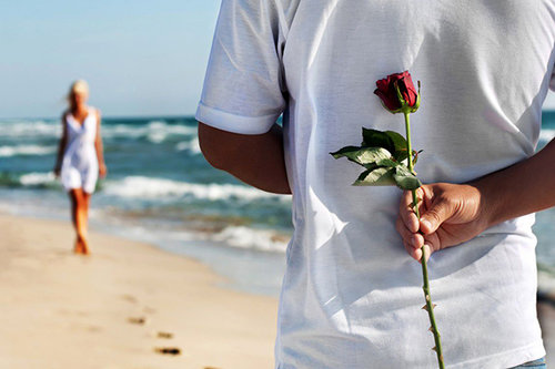 banner couple at beach guy with rose